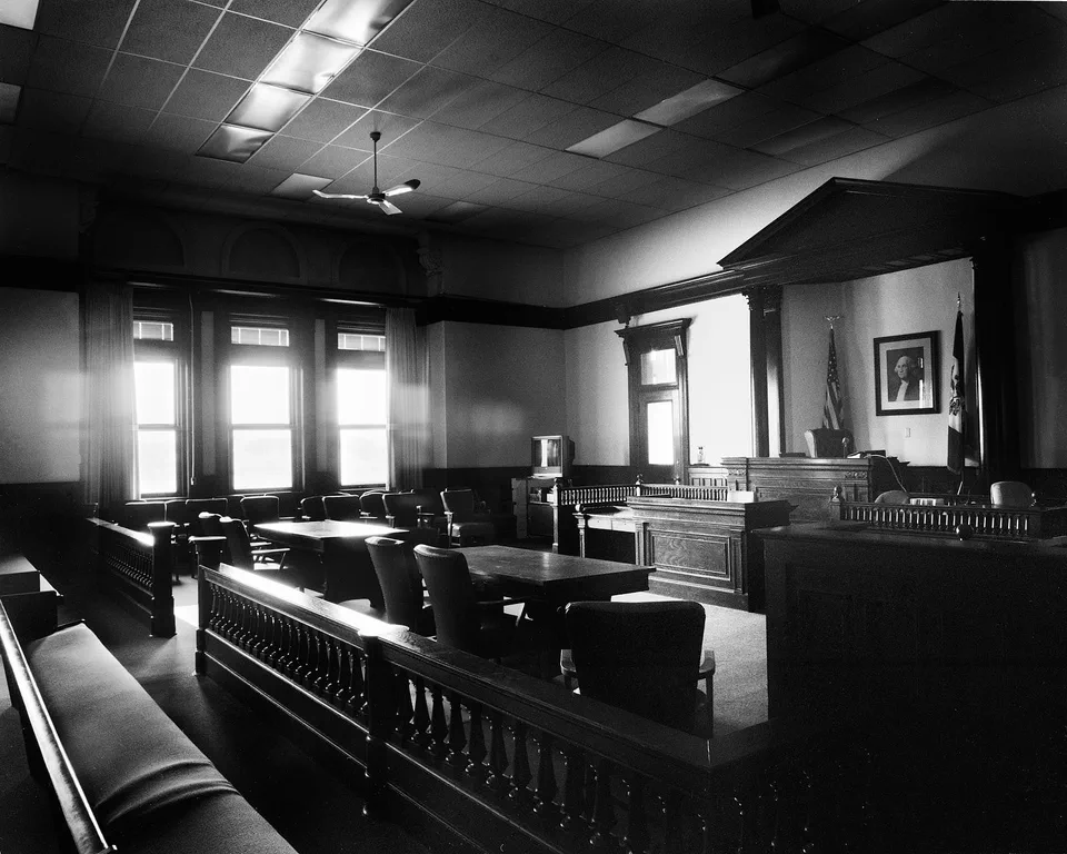 Black and white photograph of a large courtroom in Muscatine County, Iowa